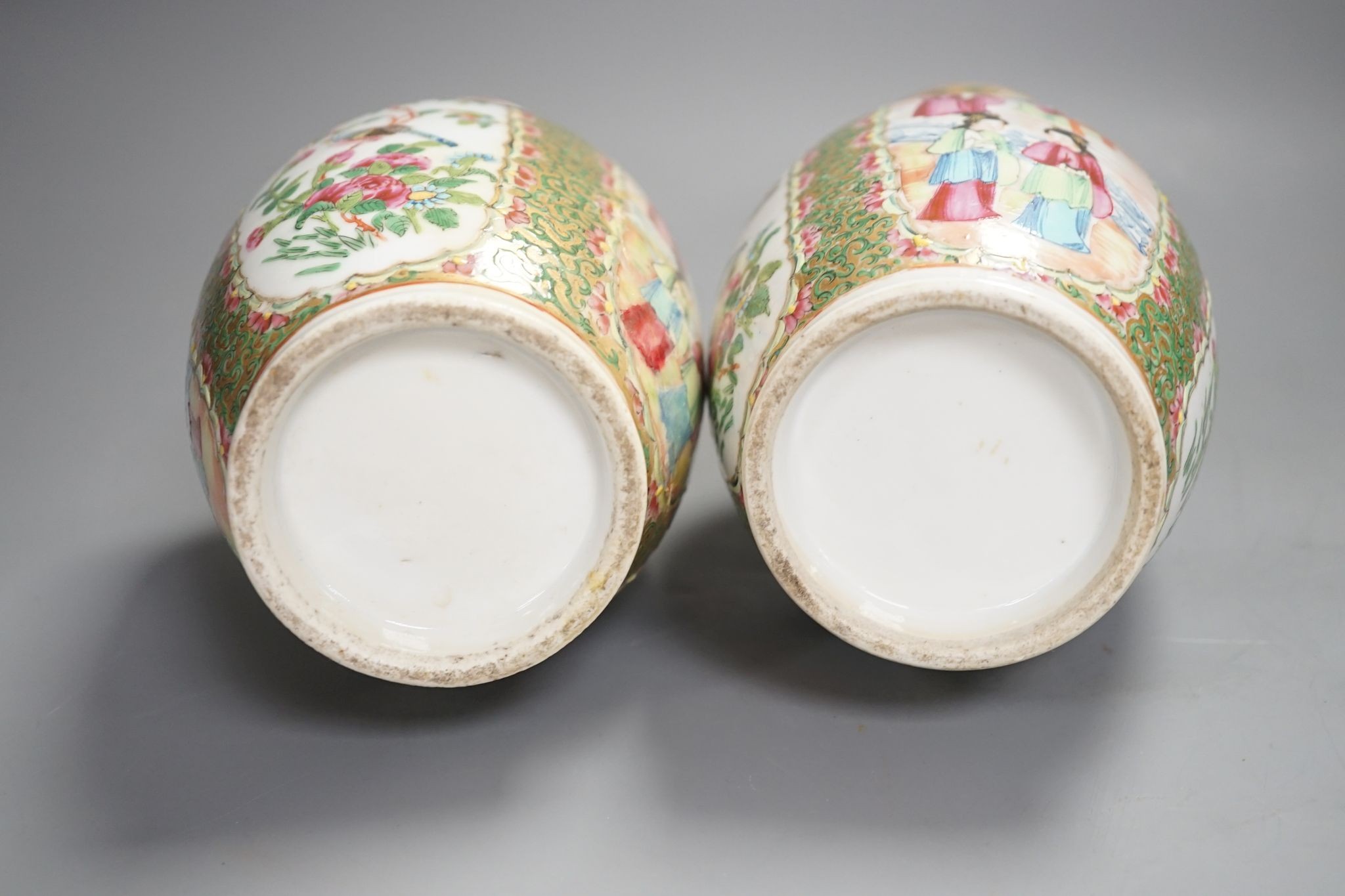 A pair of 19th century Chinese famille rose vases, 24 cms high.